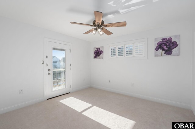 unfurnished room with light carpet, ceiling fan, and baseboards