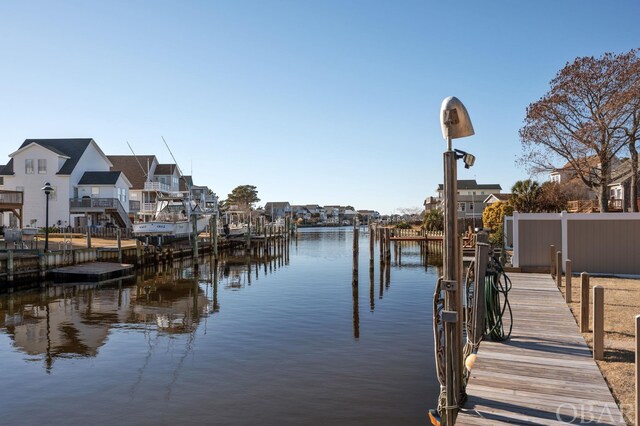 view of dock featuring a water view and a residential view