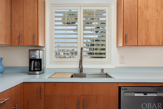 kitchen featuring brown cabinets, light countertops, and dishwasher