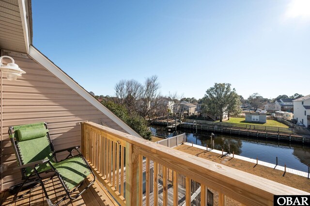 deck with a water view and a residential view