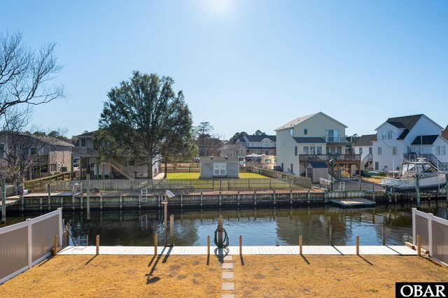 view of water feature with a residential view and a boat dock