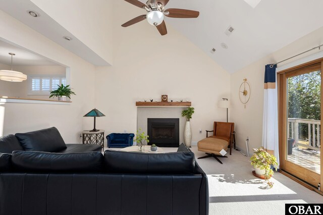 living room featuring carpet, high vaulted ceiling, plenty of natural light, and a fireplace