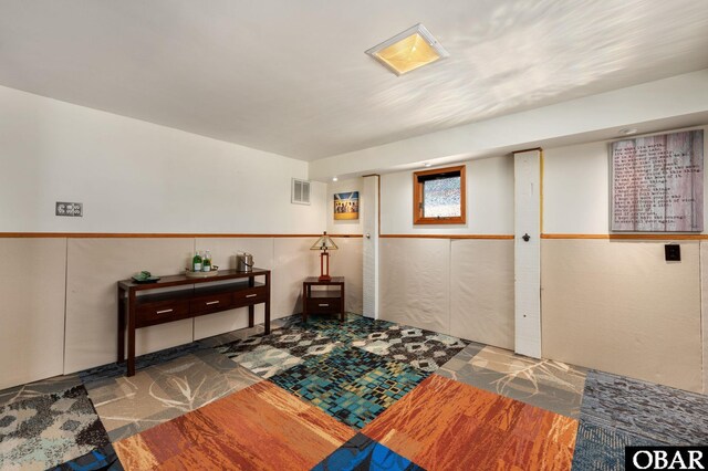 interior space with wainscoting and visible vents