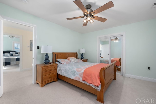 bedroom with light colored carpet, ceiling fan, visible vents, and baseboards