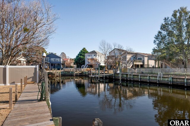 dock area with a water view and a residential view