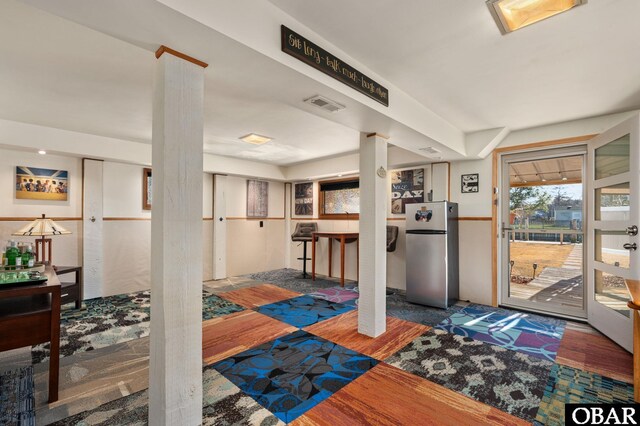 entrance foyer with wood finished floors and visible vents