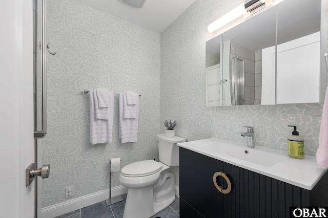 bathroom featuring toilet, baseboards, vanity, and wallpapered walls