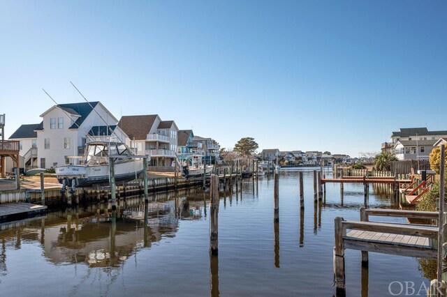 dock area with a residential view and a water view