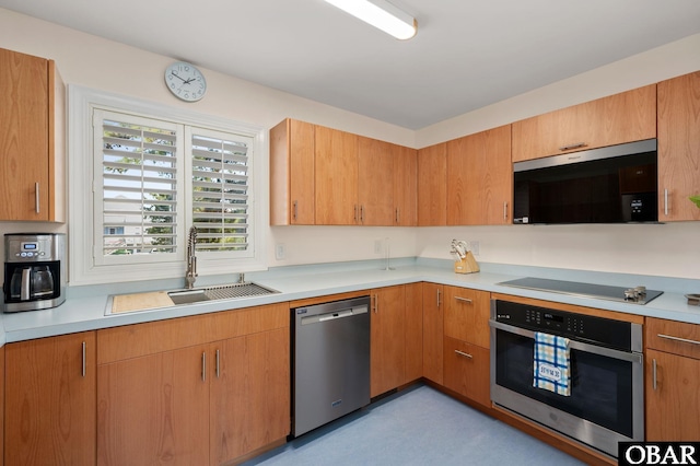 kitchen with stainless steel appliances, light countertops, and a sink