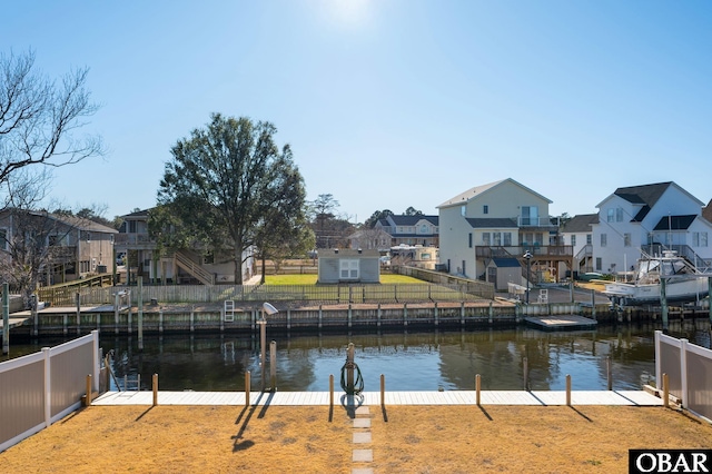 property view of water featuring a boat dock and a residential view