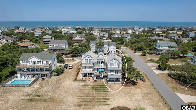 birds eye view of property featuring a water view and a residential view