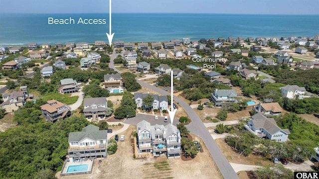 drone / aerial view with a residential view and a water view