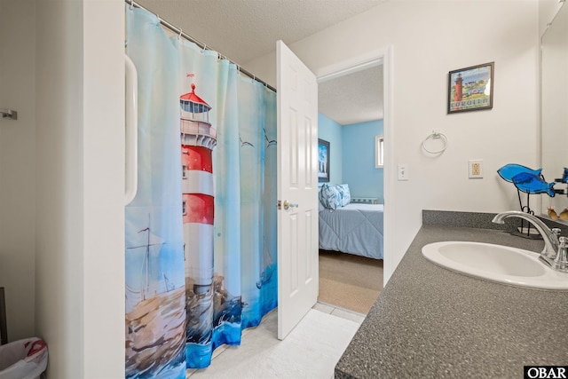 ensuite bathroom with ensuite bath, a shower with curtain, vanity, and a textured ceiling