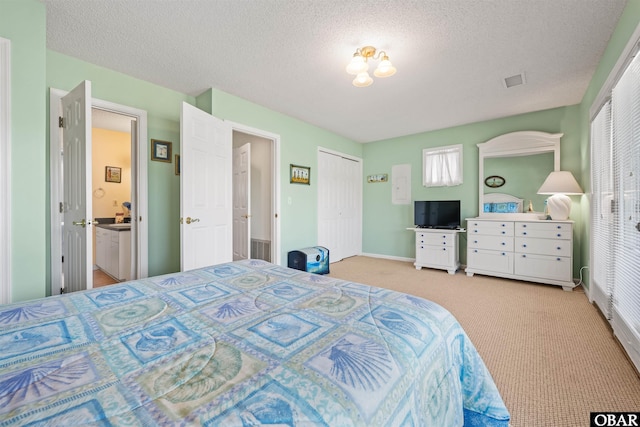 bedroom featuring visible vents, a textured ceiling, and light colored carpet