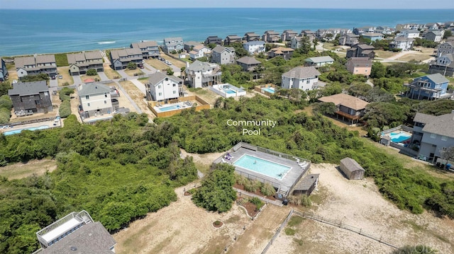 birds eye view of property featuring a water view and a residential view