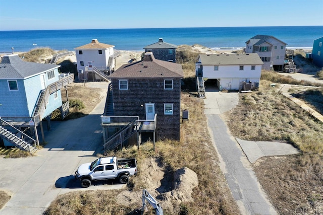 drone / aerial view with a water view and a residential view