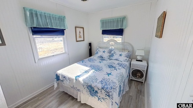 8809B S Old Oregon Inlet Rd Lot 4 & 5Ut 3, Nags Head, NC 27959 - bedroom featuring baseboards, multiple windows, and wood finished floors