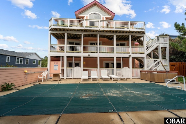 109 Duck Ridge Village Ct Lot 14, Duck, NC 27949 - rear view of property featuring a hot tub, fence, a patio, and a covered pool