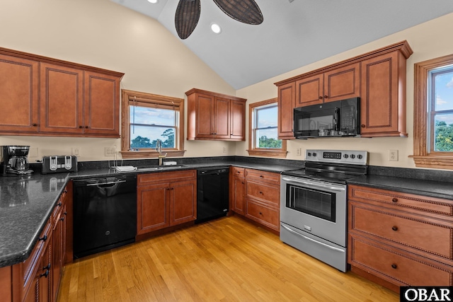 109 Duck Ridge Village Ct Lot 14, Duck, NC 27949 - kitchen featuring black appliances, a sink, light wood finished floors, brown cabinets, and high vaulted ceiling