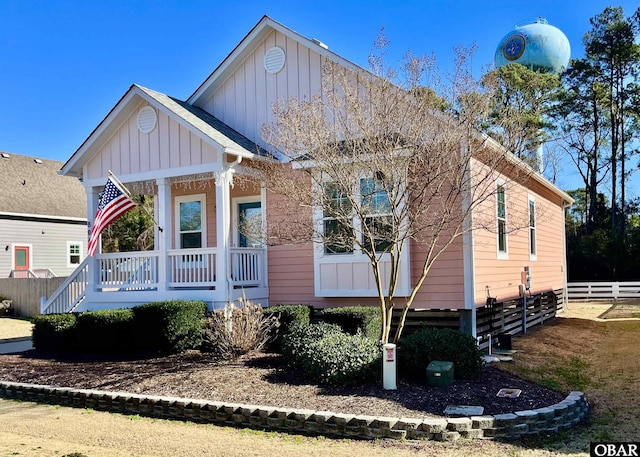 view of front facade featuring fence and board and batten siding