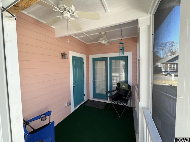 exterior space featuring a ceiling fan and a balcony