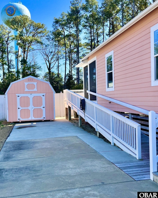 deck with an outbuilding and a storage unit