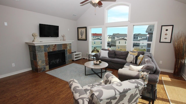 living area with baseboards, ceiling fan, a residential view, dark wood-type flooring, and a fireplace