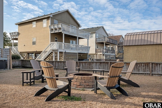 exterior space with stairway, an outdoor fire pit, fence, and a deck