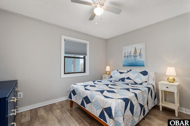 bedroom with a ceiling fan, a textured ceiling, baseboards, and dark wood-type flooring