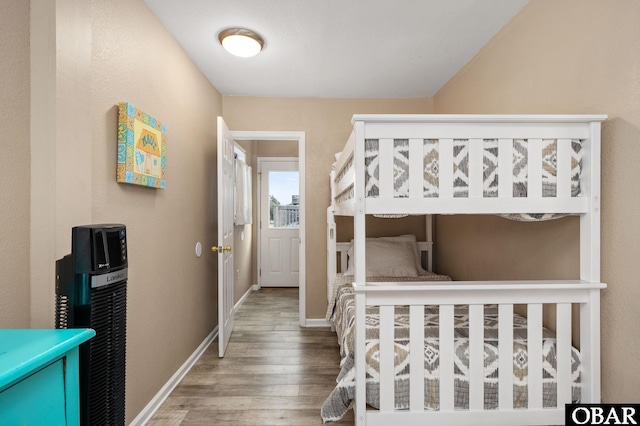 bedroom with wood finished floors and baseboards