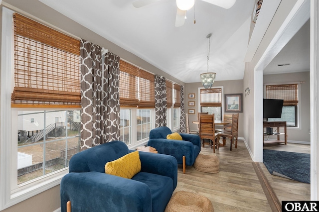 sitting room featuring a ceiling fan, visible vents, baseboards, and wood finished floors