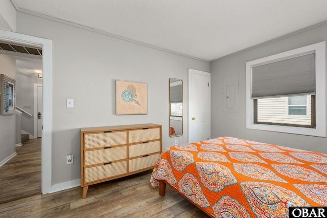 bedroom featuring wood finished floors and baseboards