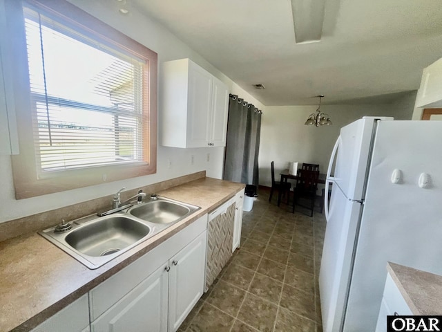 269 Lakeview Ct Lot 12, Engelhard, NC 27824 - kitchen featuring freestanding refrigerator, white cabinetry, and a chandelier
