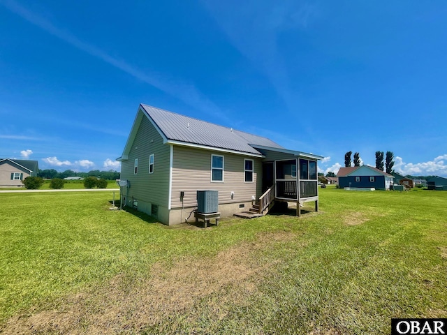 269 Lakeview Ct Lot 12, Engelhard, NC 27824 - rear view of house with a sunroom, a lawn, and a metal roof