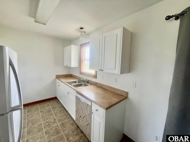 269 Lakeview Ct Lot 12, Engelhard, NC 27824 - kitchen with freestanding refrigerator, white cabinetry, and dishwashing machine