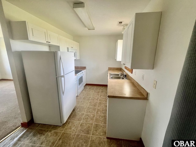 269 Lakeview Ct Lot 12, Engelhard, NC 27824 - kitchen with white appliances, white cabinets, and light tile patterned flooring