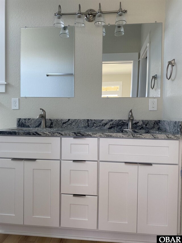 bathroom featuring double vanity and a sink