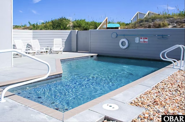 community pool featuring a patio area