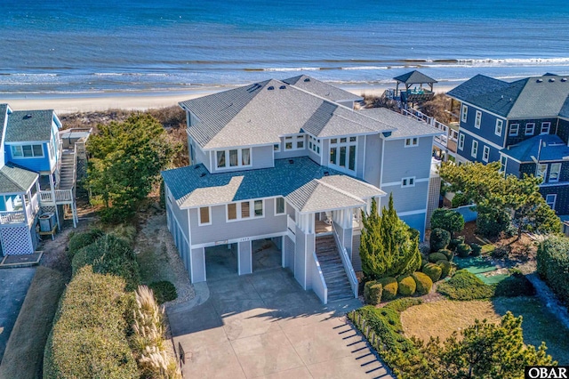 aerial view with a water view and a view of the beach