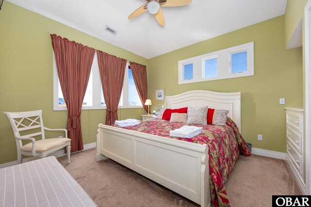 bedroom with carpet floors, visible vents, baseboards, and a ceiling fan