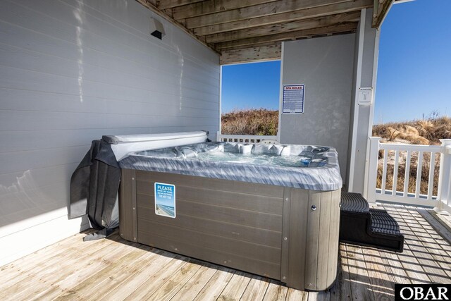 wooden terrace featuring a hot tub