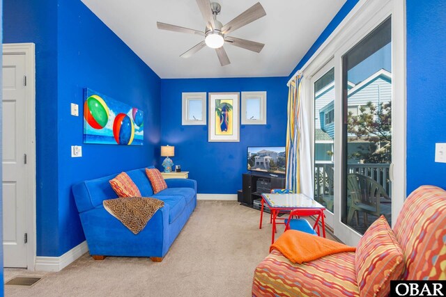 living area with ceiling fan, carpet, visible vents, and baseboards