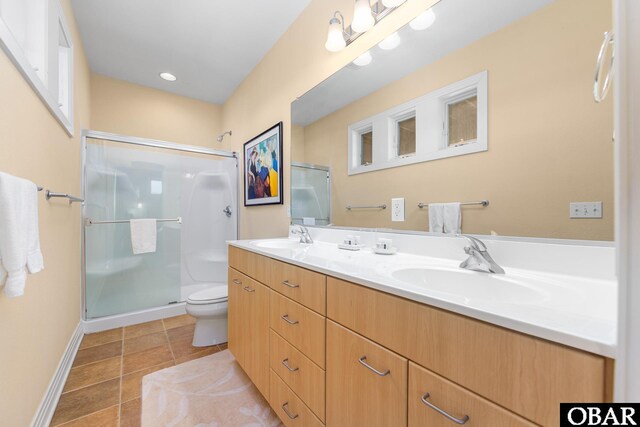 full bathroom with tile patterned flooring, a shower stall, toilet, and double vanity