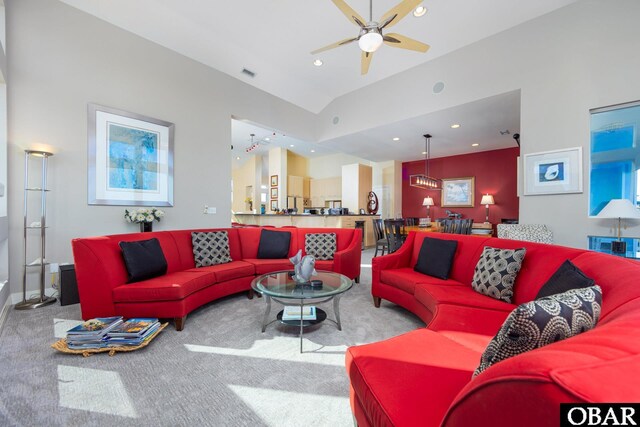 living room featuring carpet, recessed lighting, lofted ceiling, visible vents, and a ceiling fan