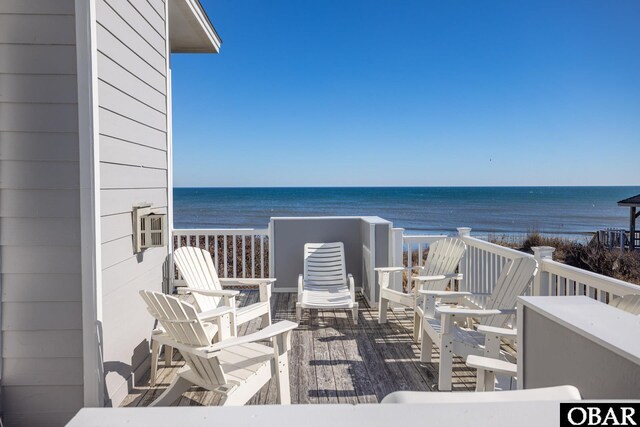 exterior space with a water view and a beach view