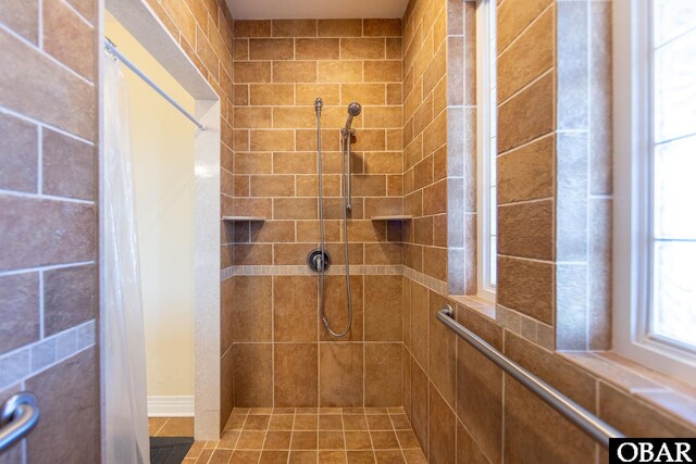 full bath featuring tiled shower