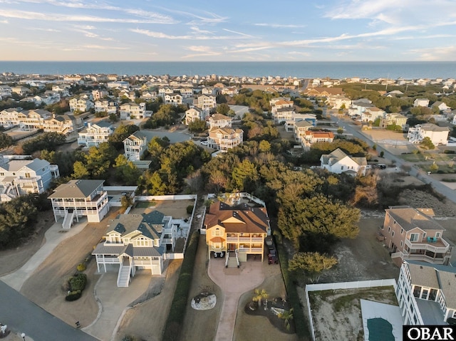 drone / aerial view with a water view and a residential view