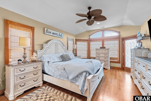 bedroom featuring lofted ceiling, access to outside, visible vents, and light wood-style floors