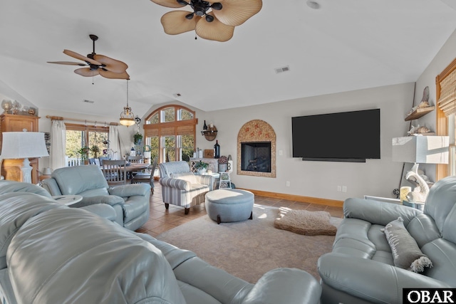 living area featuring light tile patterned floors, lofted ceiling, visible vents, a ceiling fan, and baseboards