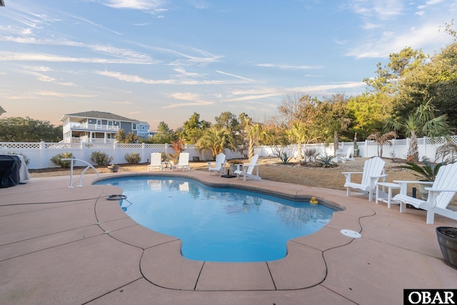 view of pool featuring a patio, a fenced backyard, a fenced in pool, and a grill